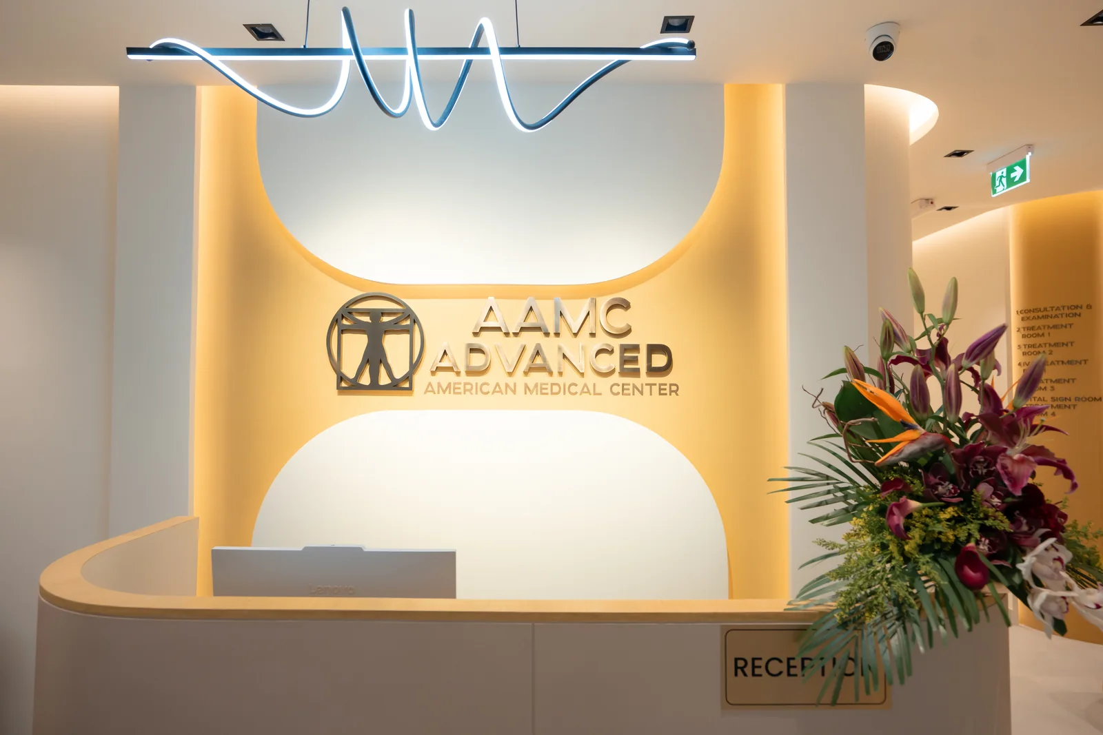 AAMC Polyclinic reception branding and warm integrated lighting