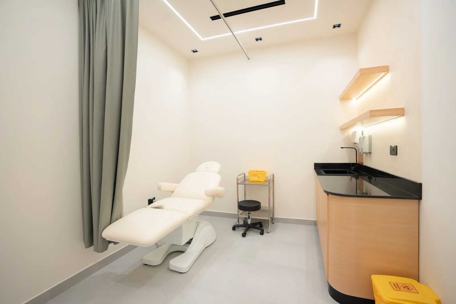 Completed AAMC treatment room with privacy curtain and clinical worktop